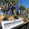 Cast members Dolph Lundgren, Jason Statham, Harrison Ford, Mel Gibson, Ronda Rousey, Sylvester Stallone, Wesley Snipes pose on a tank as they arrive on the Croisette to promote the film &quot;The Expe