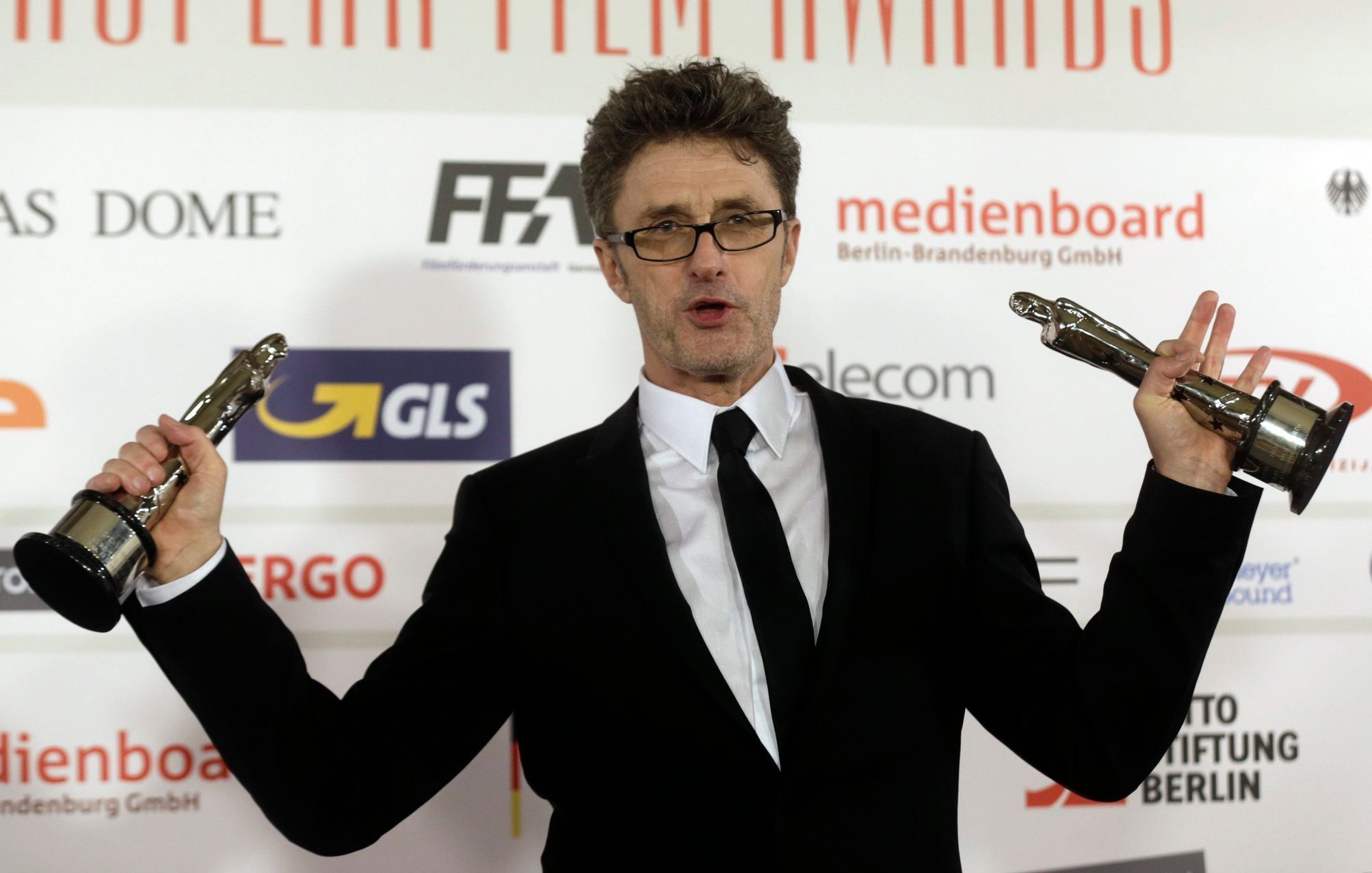 Pawlikowski poses with his trophies for European director and screenwriter for his work in the movie &quot;Ida&quot; after the European Film Awards ceremony in Riga