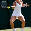 Sabine Lisicki of Germany hits a shot during her match against Timea Bacsinszky of Switzerland at the Wimbledon Tennis Championships in London