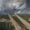 An aerial view of Highway 63 south of Fort McMurray, Alberta. Canada, shows smoke from the wildfires