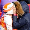 Bode Miller of the U.S. and his wife Morgan Beck kiss in the mixed zone after he finished in the men's alpine skiing Super-G competition during the 2014 Sochi Winter Olympics at the Rosa Khutor Alpine