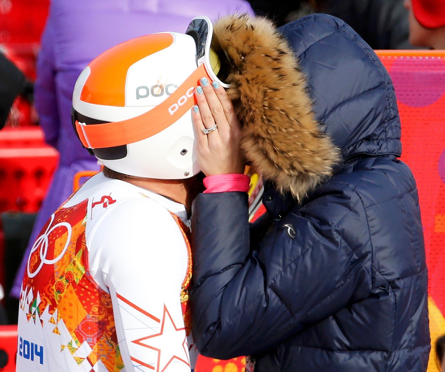 Bode Miller of the U.S. and his wife Morgan Beck kiss in the mixed zone after he finished in the men's alpine skiing Super-G competition during the 2014 Sochi Winter Olympics at the Rosa Khutor Alpine
