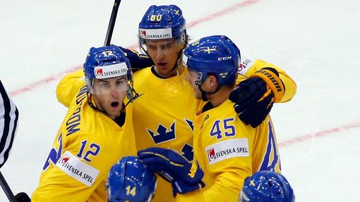 Sweden's Mikael Backlund (top) celebrates his goal against Denmark with team mates during the first period of their men's ice hockey World Championship group A game at Ch