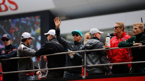 Mercedes Formula One driver Lewis Hamilton of Britain waves from a bus during the drivers' parade before the Chinese F1 Grand Prix at the Shanghai International circuit,