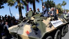 Cast members Arnold Schwarzenegger, Jason Statham and Harrison Ford pose on a tank as they arrive on the Croisette to promote the film &quot;The Expendables 3&quot; during the 67th Cannes Film Festiva