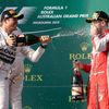 Second placed Mercedes Formula One driver Rosberg sprays champagne onto the face of third placed compatriot Ferrari driver Vettel on the podium after the Australian F1 Grand Prix in Melbourne