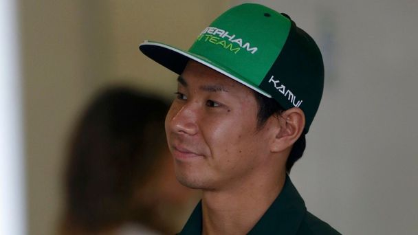 Caterham Formula One driver Kobayashi of Japan looks on in the garage during the second practice session of the Australian F1 Grand Prix in Melbourne