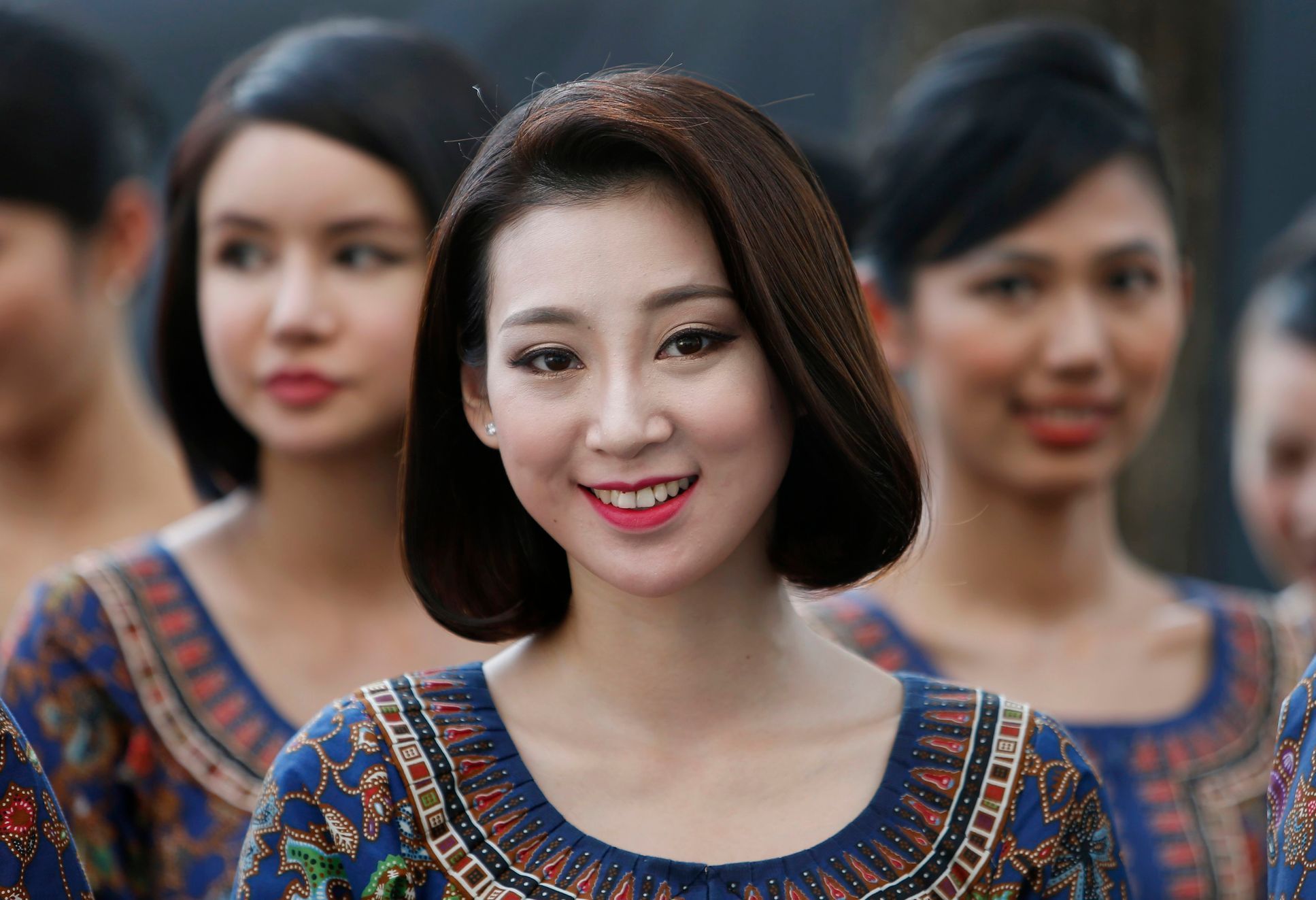 Singapore Airlines stewardesses, who will be appearing at the starting grid, stand together ahead of the Singapore F1 Grand Prix at the Marina Bay street circuit in Singapore