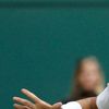 Španělský tenista Rafael Nadal vrací míček Brazilci Thomazi Beluccimu v 1. kole Wimbledonu 2012.