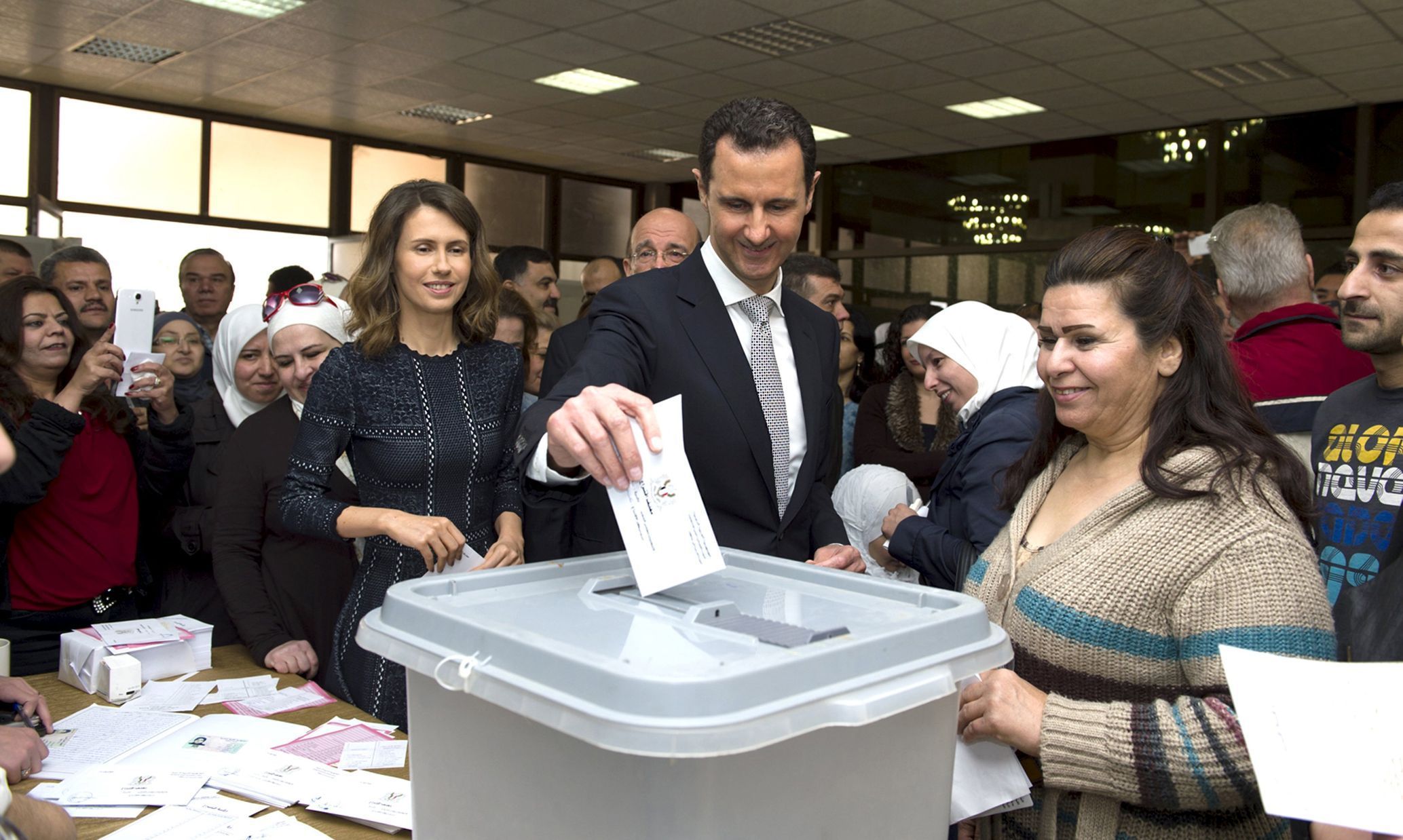 Syria's President Bashar al-Assad casts his vote next to his wife Asma inside a polling station during the parliamentary elections in Damascus