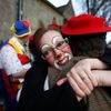 Clowns greet each other outside the All Saints Church before the Grimaldi clown service in Dalston, north London