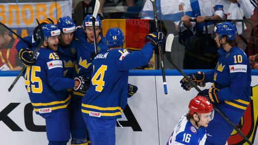 Sweden's Oscar Moller (L) celebrates his goal against Russia with team mates during the first period of their men's ice hockey World Championship semi-final game at Minsk