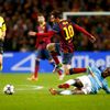Manchester City's Yaya Toure challenges Barcelona's Lionel Messi during their Champions League round of 16 first leg soccer match at the Etihad Stadium in Manchester