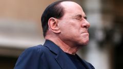 File photo of Berlusconi closing his eyes in a gesture to supporters during a rally to protest his tax fraud conviction, outside his palace in central Rome