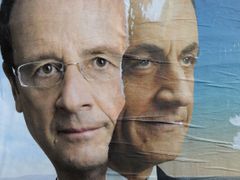 Official campaign posters for Sarkozy and Hollande for the French presidential election are displayed on a wall in Paris