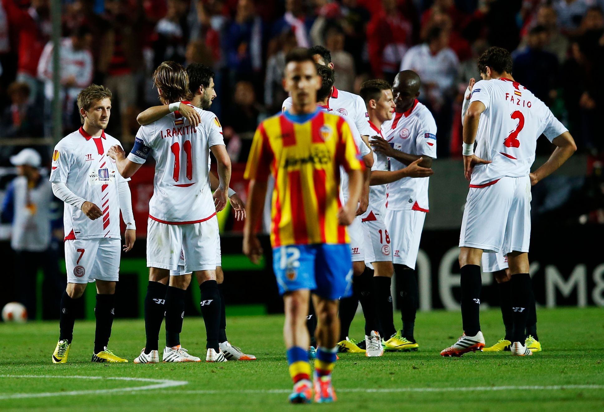 Sevilla's players celebrate winning after the end of their soccer match against Valencia in Seville