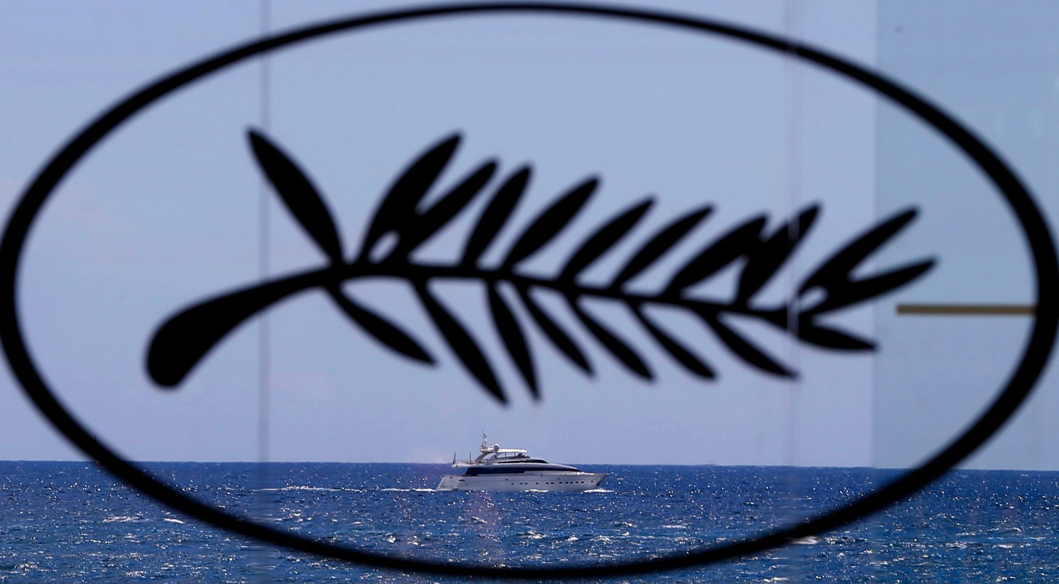 A yacht is seen in the Bay of Cannes through a Palme d'Or symbol on the eve of the opening of the 67th Cannes Film Festival in Cannes