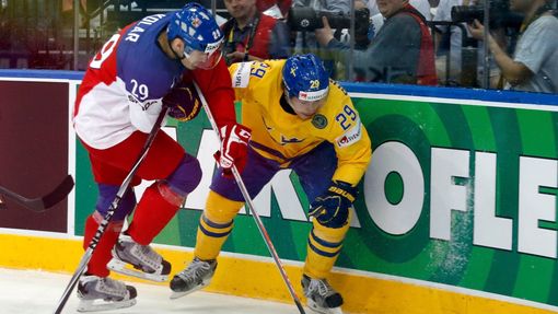 Sweden's Erik Gustafsson (L) is checked into the boards by Jan Kolar of the Czech Republic (R) during the first period of their men's ice hockey World Championship bronze