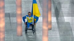 Ukraine's flag-bearer Tkachenko arrives in the stadium during the opening ceremony of the 2014 Paralympic Winter Games in Sochi