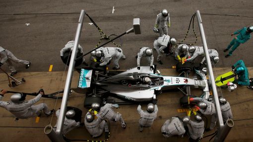 Crew members of Mercedes Formula One driver Lewis Hamilton of Britain service the car at pit stop during the Spanish F1 Grand Prix at the Barcelona-Catalunya Circuit in M