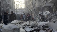 Residents inspect damage after airstrikes by pro-Syrian government forces in the rebel held Al-Shaar neighborhood of Aleppo, Syria