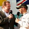 Race winner Mercedes Formula One driver Lewis Hamilton of Britain and actor Arnold Schwarzenegger speak during the podium ceremony of the Australian F1 Grand Prix at the Albert Park circuit in Melbour