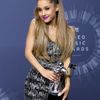 Recording artist Ariana Grande poses backstage with her award for best pop video during the 2014 MTV Video Music Awards in Inglewood
