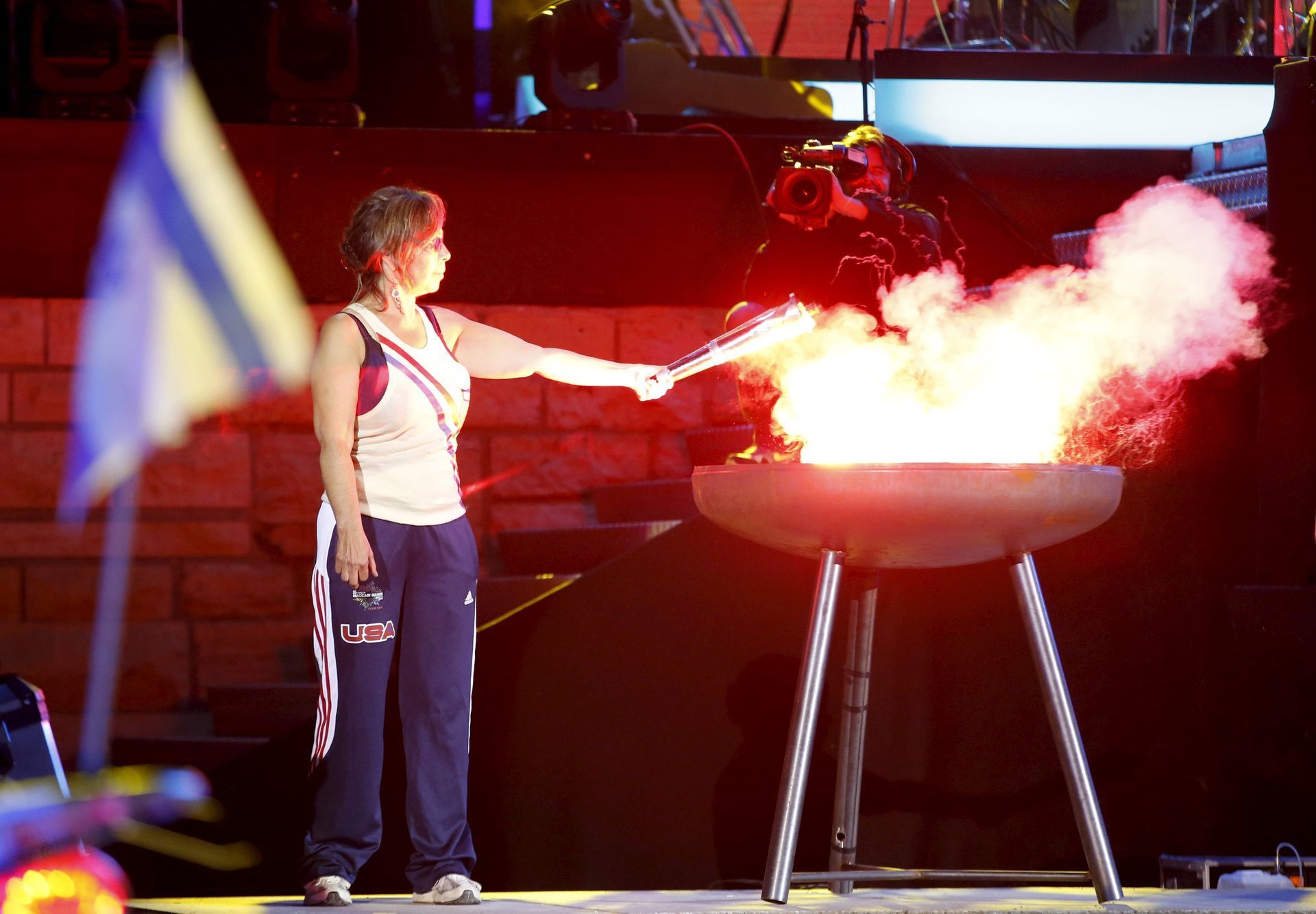 Nancy Luckman of the U.S. lights the flame during the opening ceremony of the 14th European Maccabi Games in Berlin, Germany
