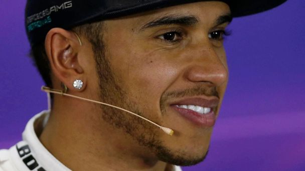 Mercedes Formula One driver Lewis Hamilton of Britain smiles during a news conference following the qualifying session of the Australian F1 Grand Prix at the Albert Park circuit in Melbourne