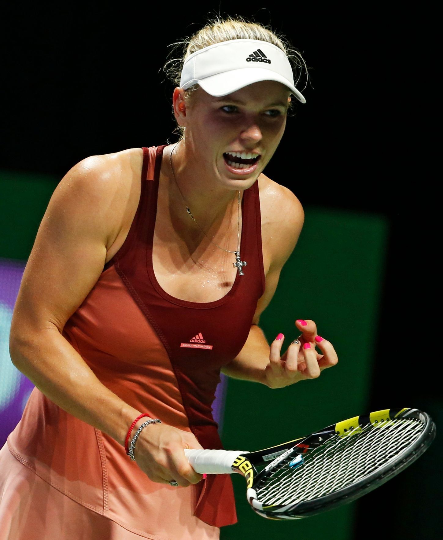Caroline Wozniacki of Denmark screams after losing a point against Agnieszka Radwanska of Poland during their WTA Finals singles tennis match at the Singapore Indoor Stadium