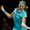 Kvitova of the Czech Republic hits a return to Sharapova of Russia during their WTA Finals singles tennis match at the Singapore Indoor Stadium