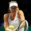 Maria Sharapova of Russia hits a return to Petra Kvitova of the Czech Republic during their WTA Finals singles tennis match at the Singapore Indoor Stadium