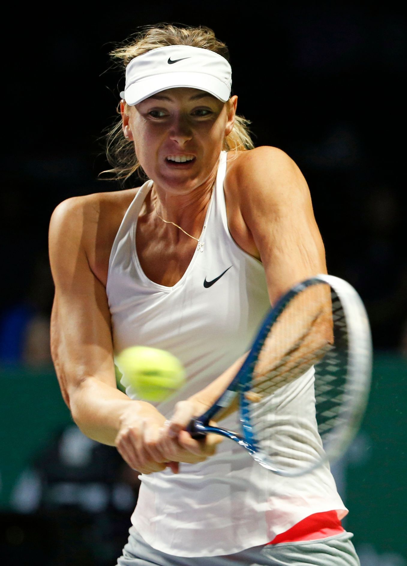 Maria Sharapova of Russia hits a return to Petra Kvitova of the Czech Republic during their WTA Finals singles tennis match at the Singapore Indoor Stadium