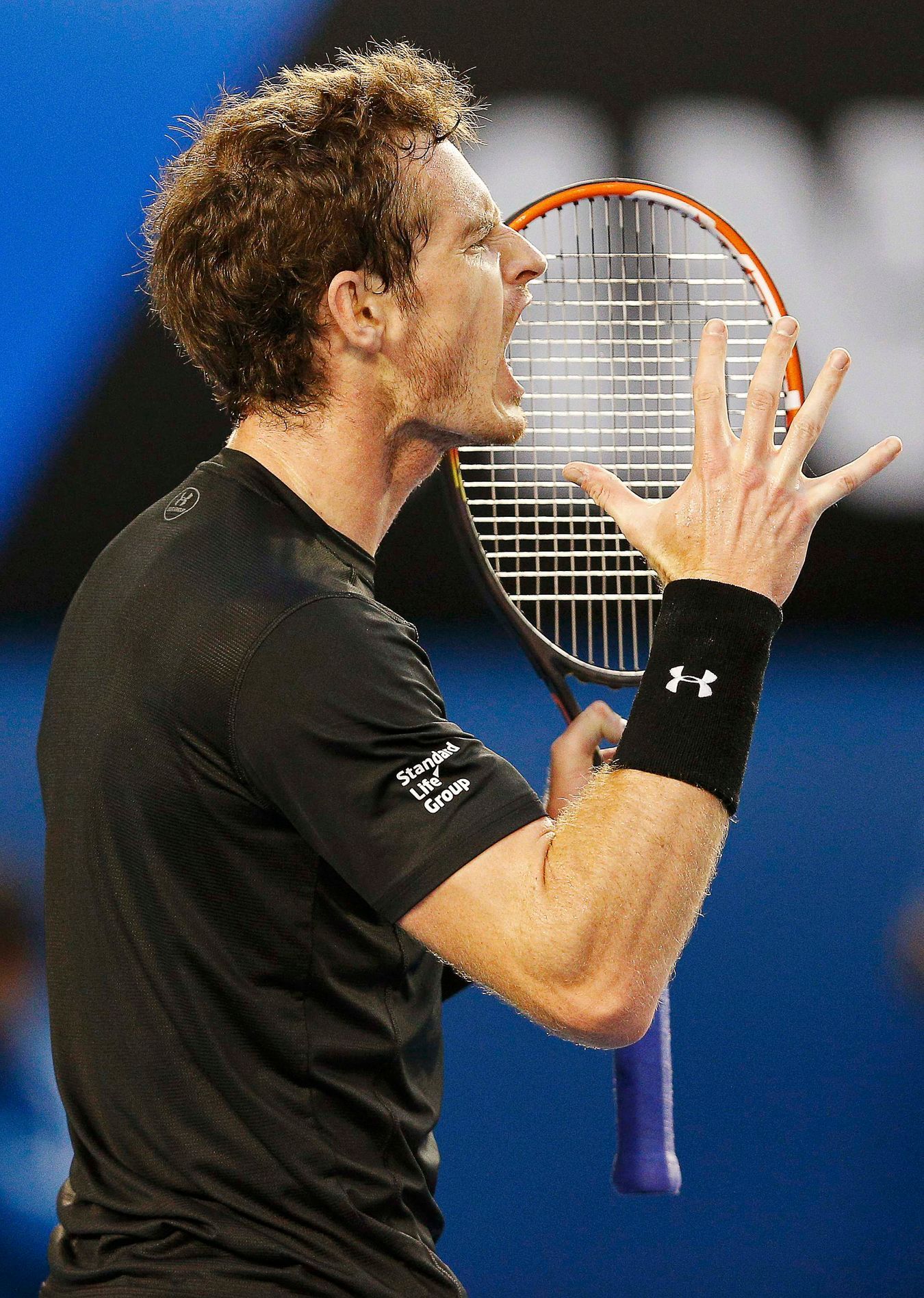 Murray of Britain reacts after hitting a shot to Djokovic of Serbia during their men's singles final match at the Australian Open 2015 tennis tournament in Melbourne
