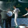 Mercedes Formula One driver Nico Rosberg of Germany and team mate Lewis Hamilton of Britain spray champgane at F1 legend Jackie Stewart during the podium ceremony after the Australian F1 Grand Prix at
