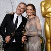 Cuaron poses with the Oscars for best director and for best film editing for &quot;Gravity&quot; with presenter Jolie backstage at the 86th Academy Awards in Hollywood