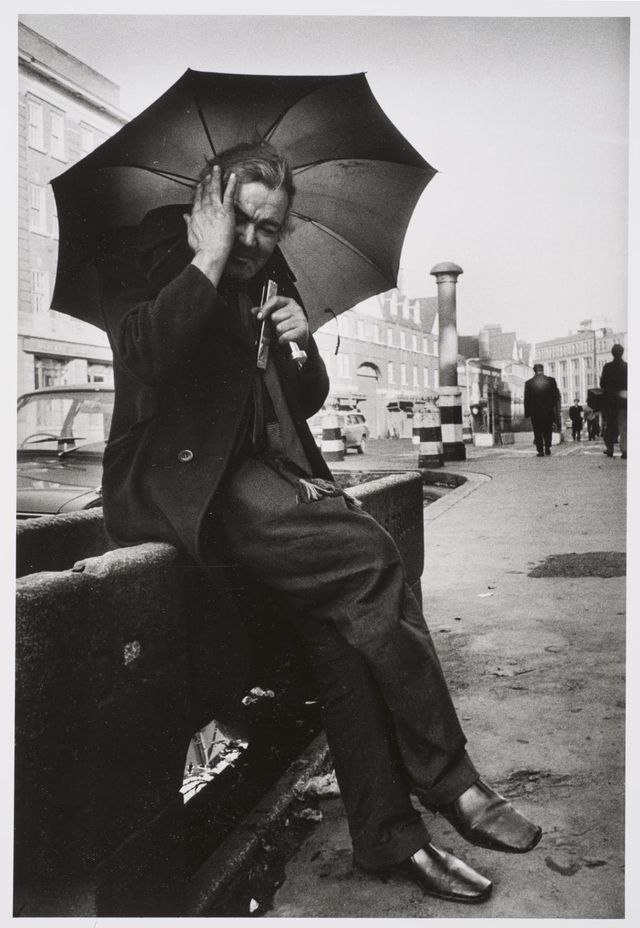 Marketa Luskačová: Man plays his mouth and limbs in front of the Christchurch, Commercial Road, London, 1978