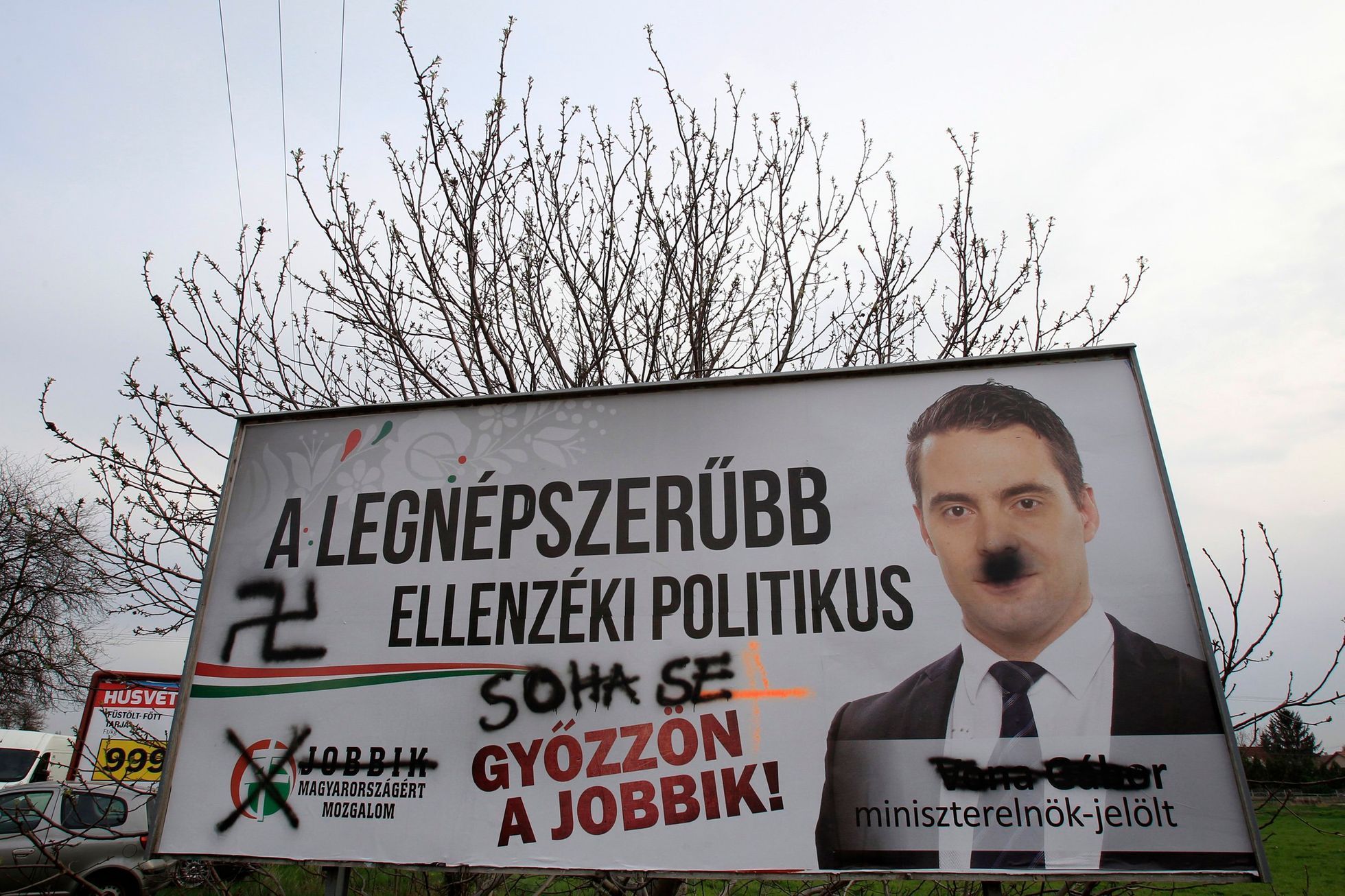A defaced election poster of far-right Jobbik party leader Gabor Vona is seen in Budapest