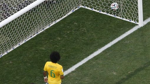 Brazil's Julio Cesar (L) watches after teammate Marcelo scored an own goal during the 2014 World Cup opening match against Croatia at the Corinthians arena in Sao Paulo J