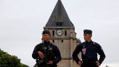 French CRS police stand guartd in front of the church a day after a hostage-taking in Saint-Etienne-du-Rouvray near Rouen in Normandy