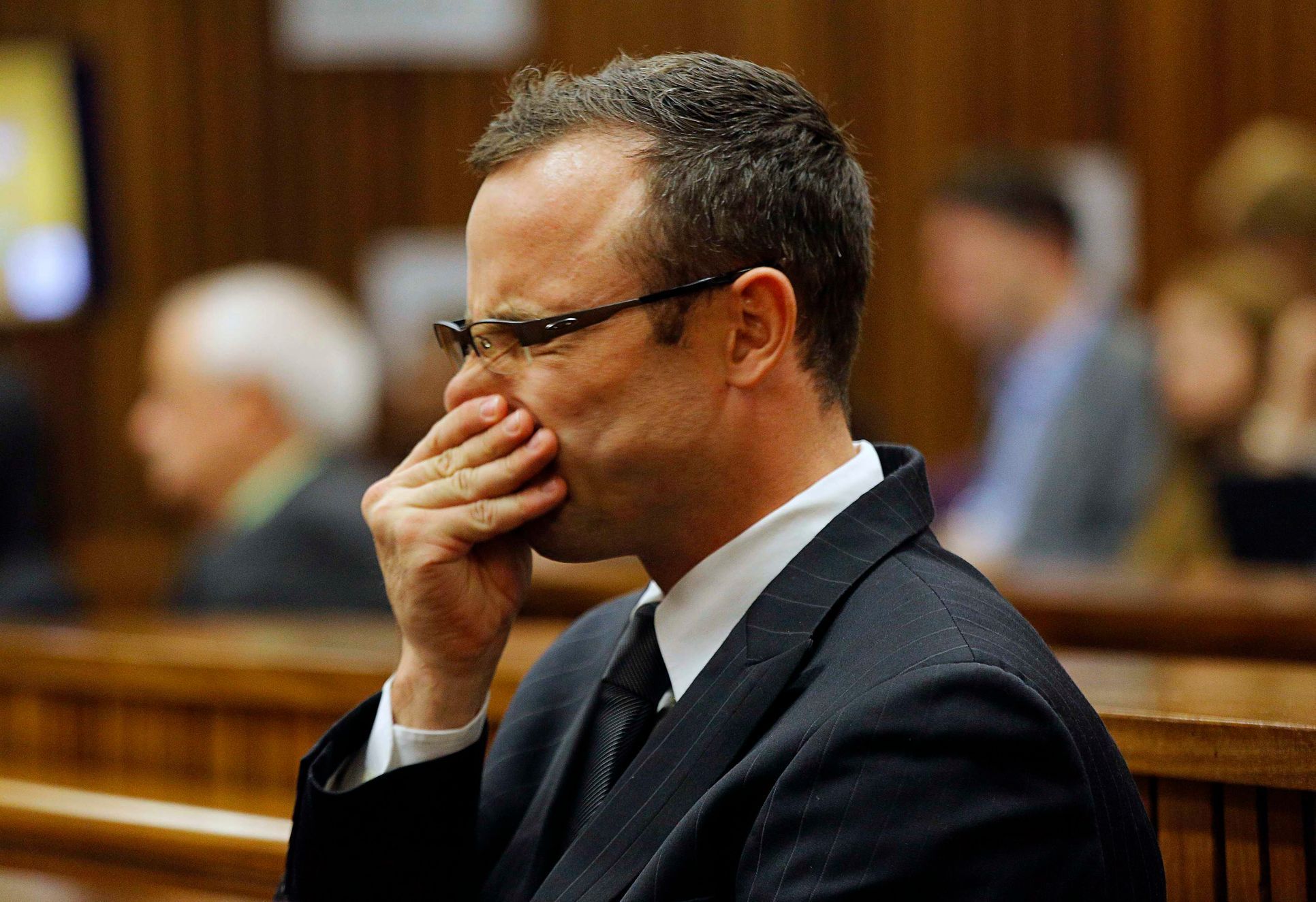 Olympic and Paralympic track star Oscar Pistorius sits in the dock at the North Gauteng High Court in Pretoria