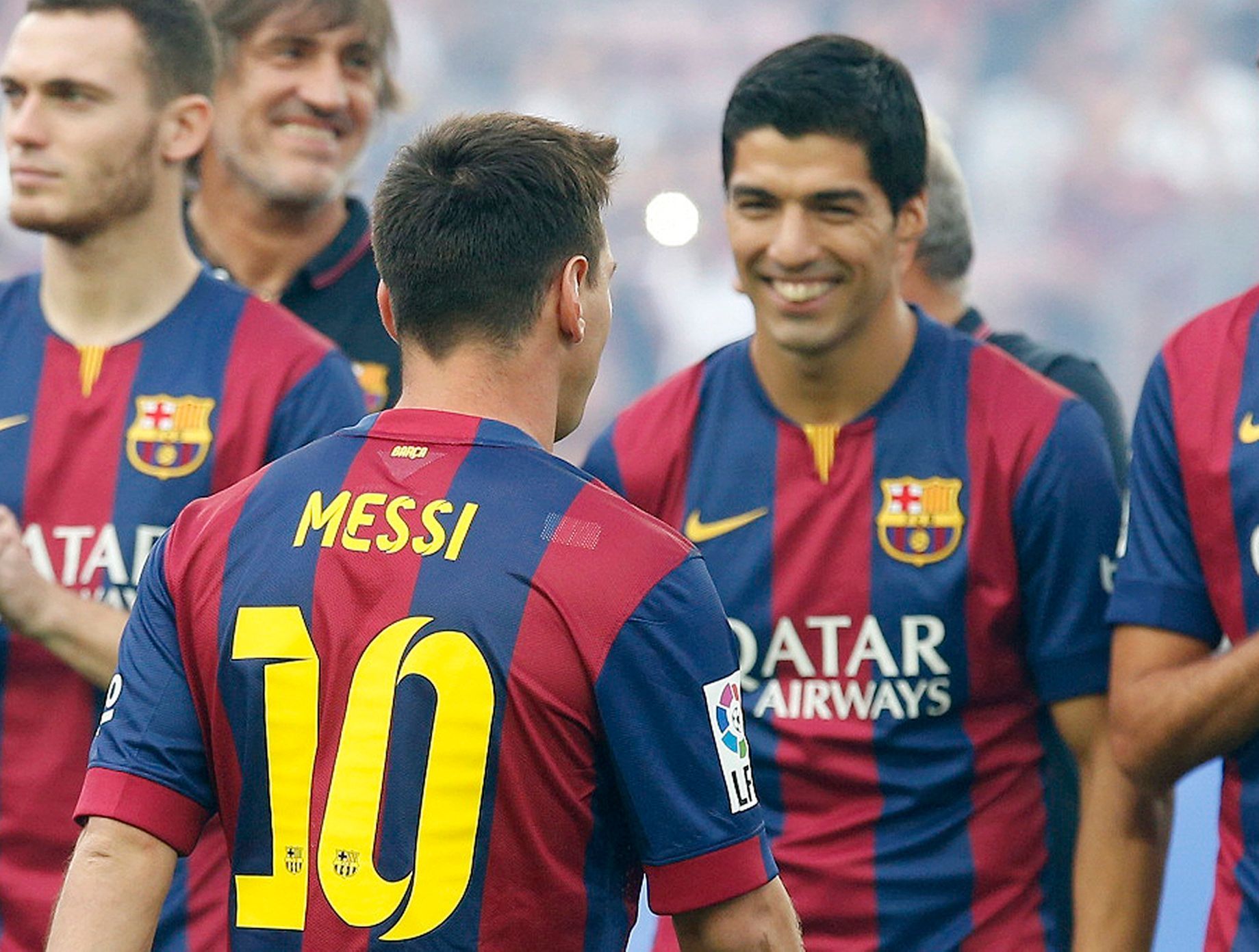 FC Barcelona's player Suarez smiles to teammate Messi during their team presentation at Nou Camp stadium in Barcelona