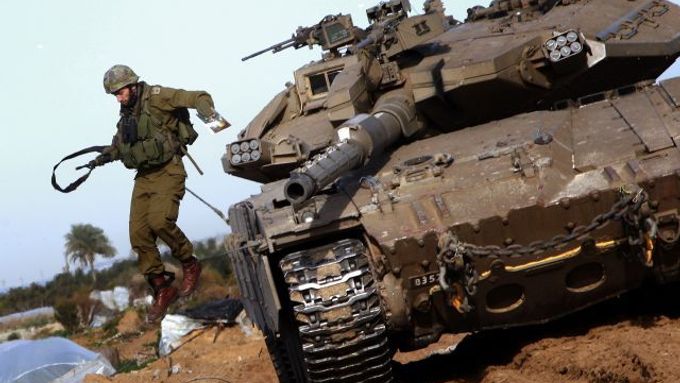 Izraelský voják vyskakuje z tanku na severu pásma Gazy.