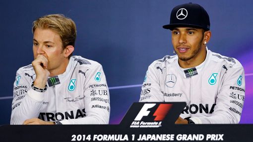 Mercedes Formula One driver Lewis Hamilton of Britain and teammate Nico Rosberg (L) of Germany attend a news conference after the Japanese F1 Grand Prix at the Suzuka Cir