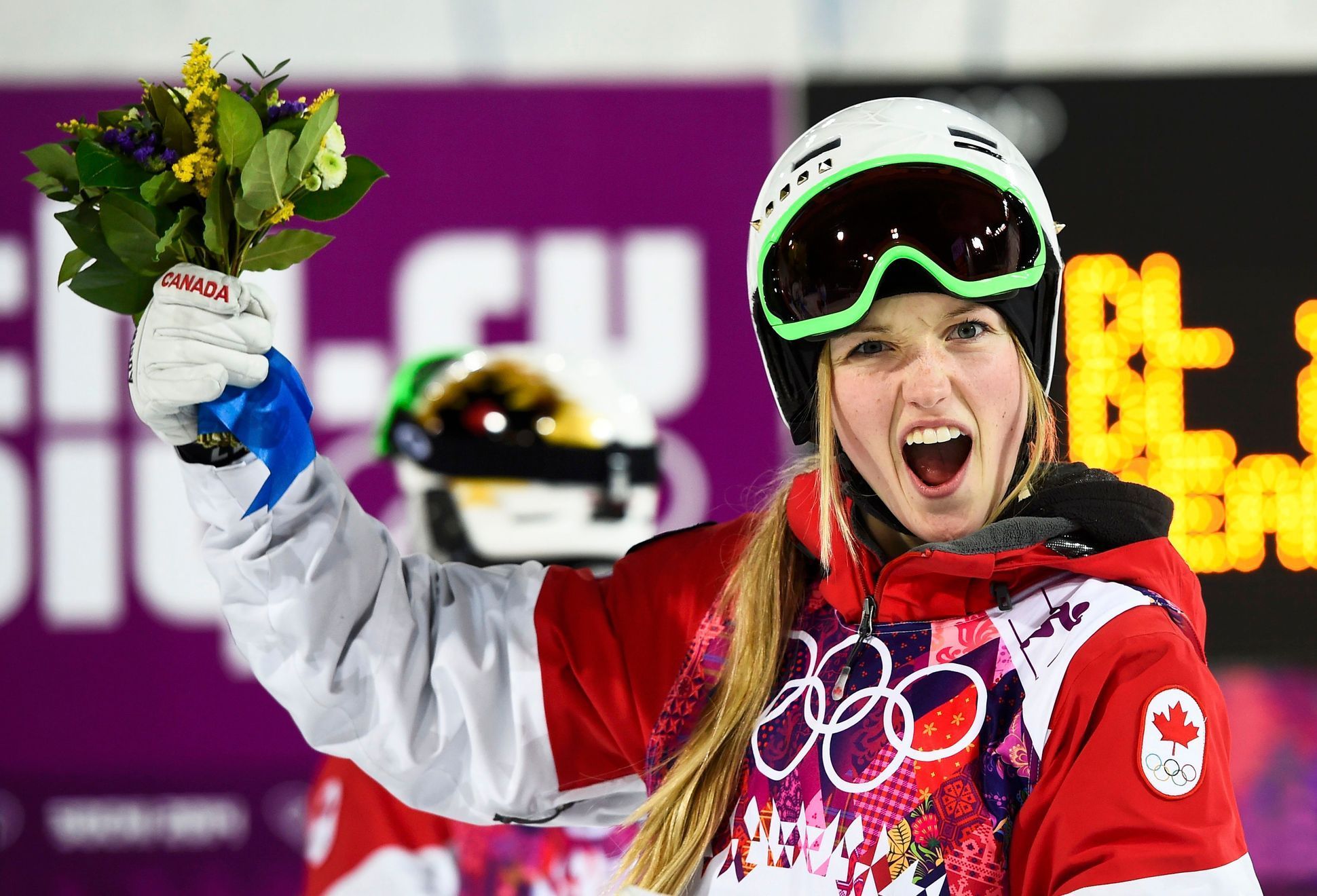 Canada's Justine Dufour-Lapointe celebrates victory after the women's freestyle skiing moguls final competition at the 2014 Sochi Winter Olympic Games in Rosa Khutor