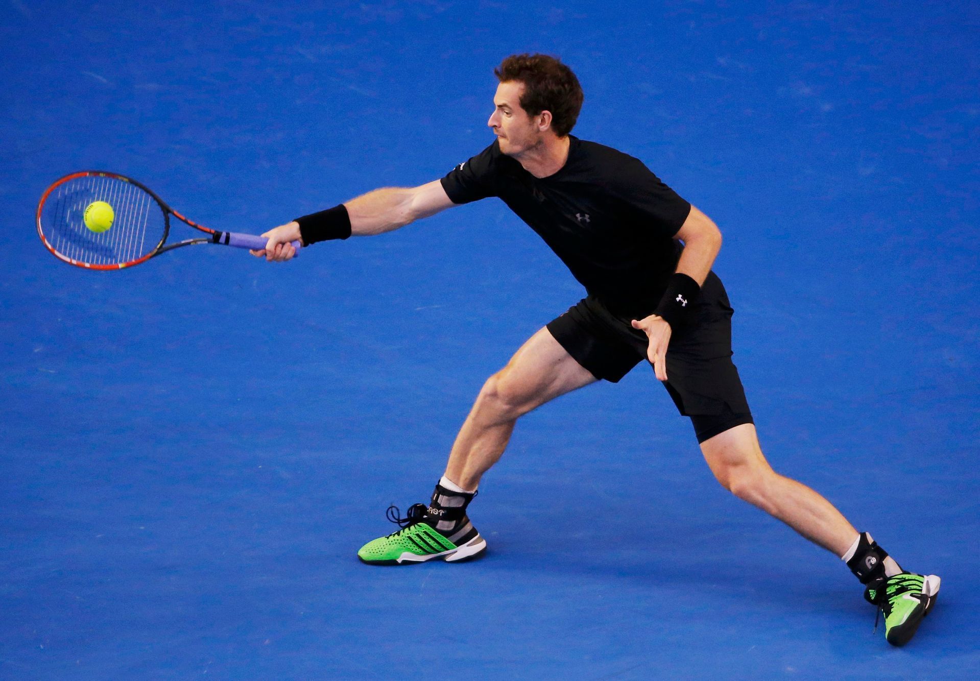 Andy Murray of Britain hits a return to Novak Djokovic of Serbia during their men's singles final match at the Australian Open 2015 tennis tournament in Melbourne