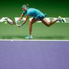 Kvitova of the Czech Republic hits a return to Radwanska of Poland during their WTA Finals singles tennis match at the Singapore Indoor Stadium