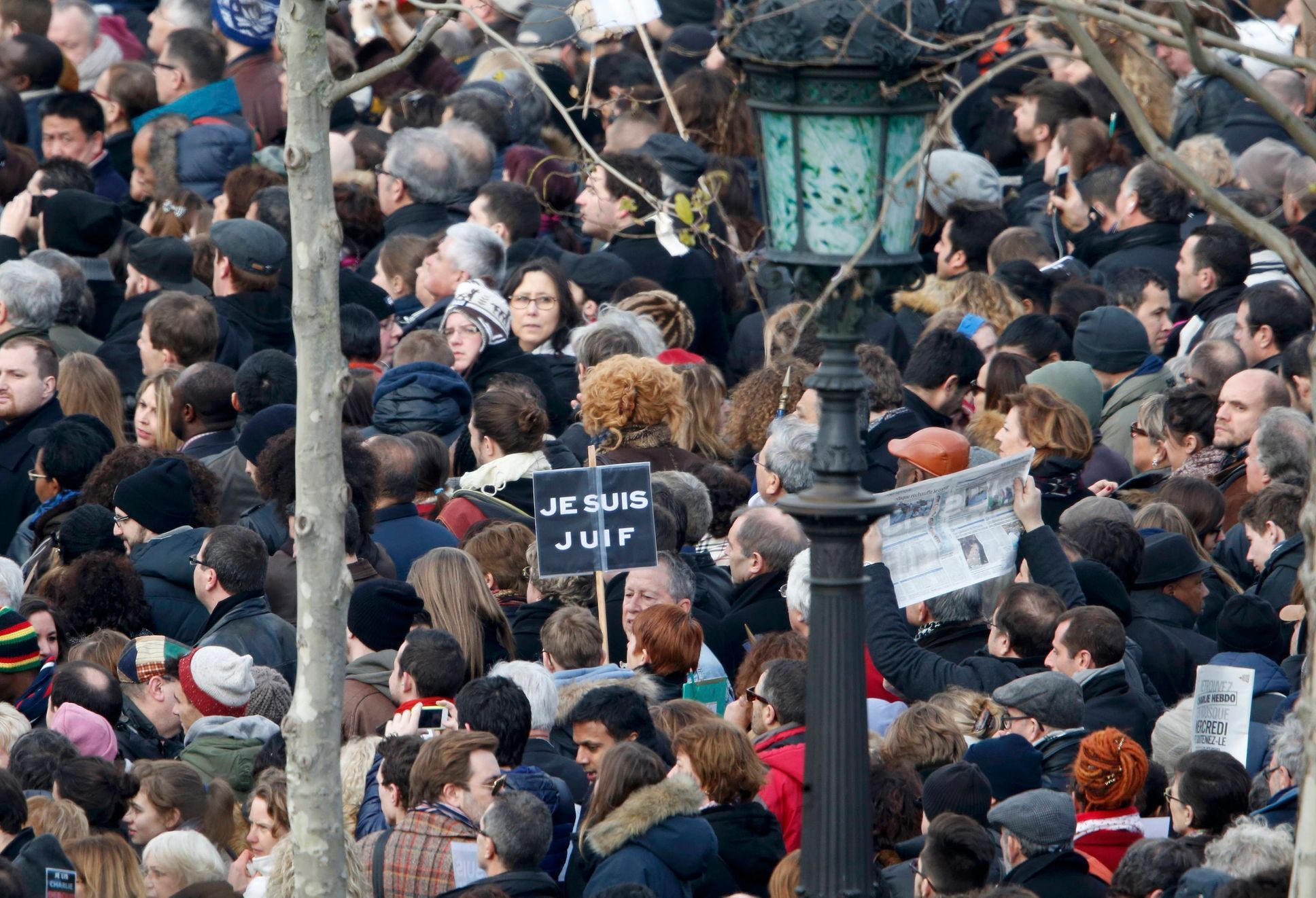 People gather on the Place de la Republique to attend the solidarity march in the streets of Paris