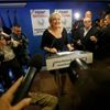 Journalists surround Marine Le Pen, France's National Front political party head, who reacts to results after the polls closed in the European Parliament elections at the party's headquarters in Nante
