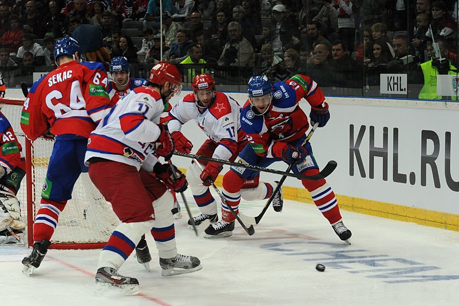Hokejisté Lva Praha Jiří Sekáč (vlevo) a Jiří Novotný v souboji s Vledimirem Žarkovem a Pavlem Dacjukem v utkání KHL proti CSKA Moskva.